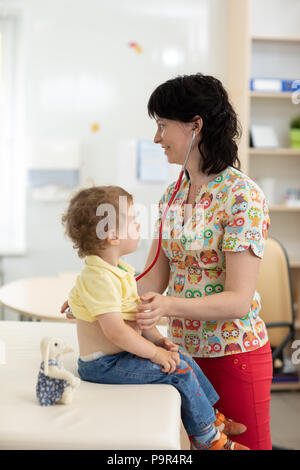 Doctor examining little kid with stethoscope Stock Photo