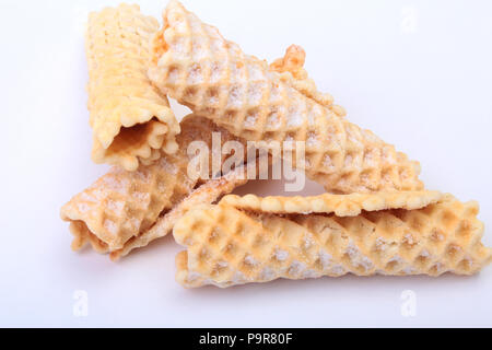 Homemade wafer rolls with powdered sugar isolated on white background Stock Photo