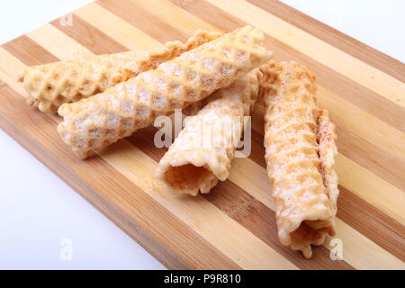 Homemade wafer rolls with powdered sugar isolated on white background Stock Photo