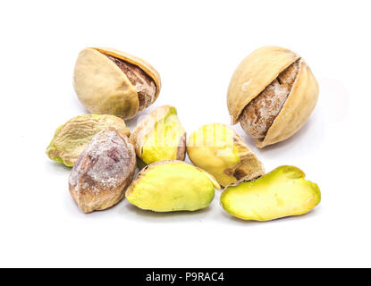 Pistachio nuts isolated on white background, some without shells Stock Photo