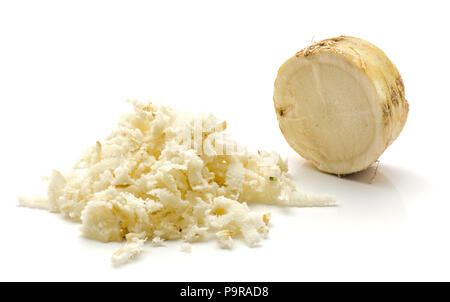 Freshly grated mash of horseradish root isolated on white background and one sliced circle Stock Photo