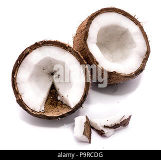 Two coconut halves and meat pieces isolated on white background Stock Photo