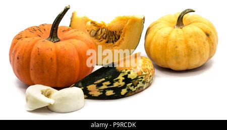 Two whole orange and yellow pumpkin, yellow and white slices with seeds isolated on white background Stock Photo