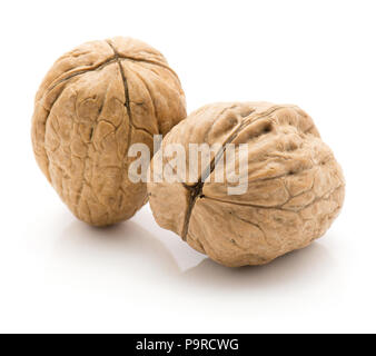Two unshelled walnuts isolated on white background Stock Photo