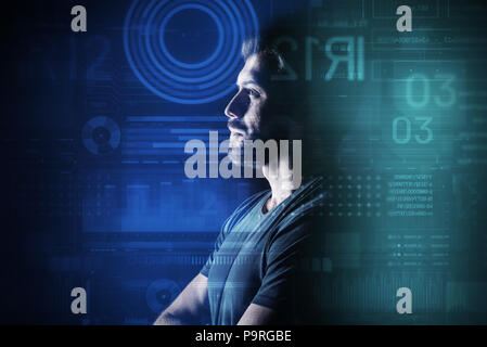 Thoughtful database administrator. Clever database administrator thoughtfully looking at the information on a transparent screen while working Stock Photo