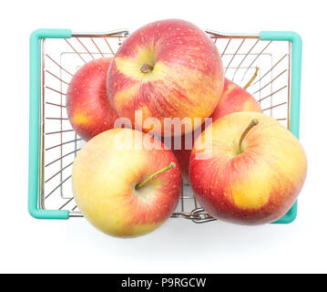 Five apples (Evelina variety) in a shopping basket top view isolated on white background red yellow Stock Photo