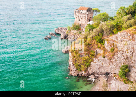 view of old medieval fort tower on rocks by Mediterranean sea near Vietri Sul Mare, Salerno, Amalfi coast, Campania province, taly
