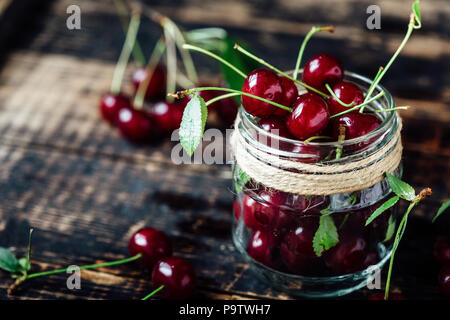 Fresh ripe cherries on a wooden table. Wooden background Stock Photo