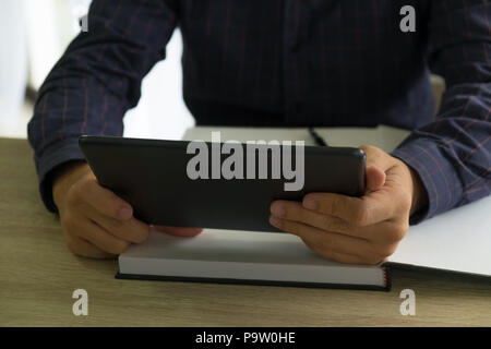Businessman using tablet to the situation on the market value , Business concept Stock Photo