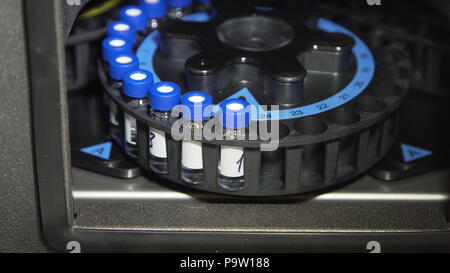 Medical centrifuge for mixing in the laboratory. Tubes prepared in lab centrifuge machine . Modern technologies in medical equipment Stock Photo