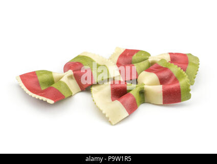 Farfalle pasta with green spinach and orange carrot isolated on white background raw classic traditional Italian three pieces Stock Photo