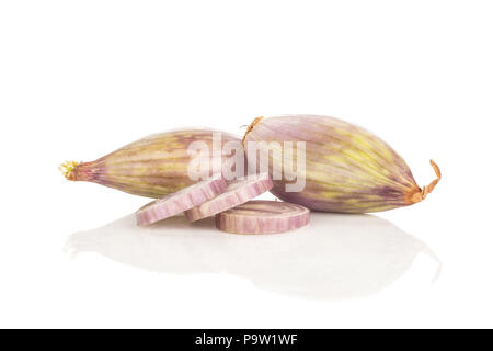 Two peeled shallots and three ring slices isolated on white background Stock Photo