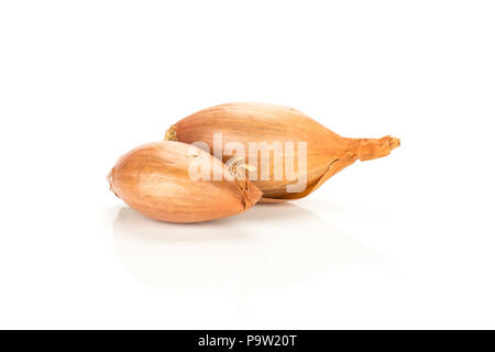 Two unpeeled golden shallots isolated on white background Stock Photo