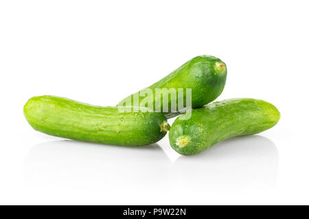 Three fresh green mini cucumbers isolated on white background Stock Photo
