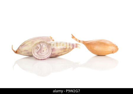 Two peeled shallots one in a husk and a ring slice isolated on white background Stock Photo