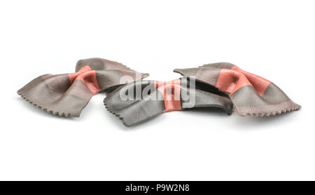 Farfalle pasta with black cuttlefish ink isolated on white background three raw classic traditional Italian Stock Photo