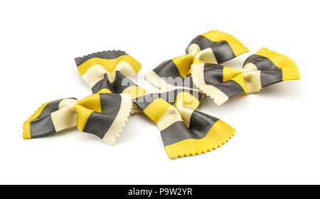 Farfalle pasta with curcuma and cuttlefsh ink isolated on white background raw classic traditional Italian yellow black five pieces set Stock Photo