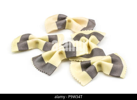 Farfalle pasta with black cuttlefish ink isolated on white background raw classic traditional Italian five pieces stack Stock Photo