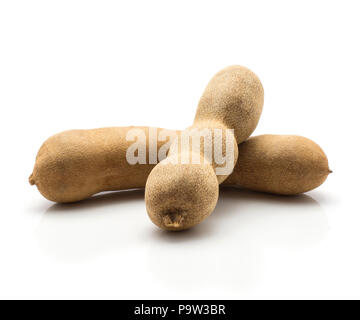 Two brown tamarind isolated on white background Indian dates in a brittle shell Stock Photo