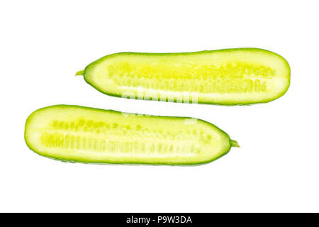 Two fresh mini cucumbers section halves flatlay isolated on white background Stock Photo