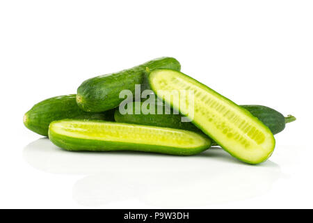 Fresh green mini cucumbers stack and two section halves isolated on white background Stock Photo
