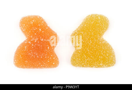 Two jelly Easter bunnies top view isolated on white background two marmalade sweets yellow lemon and orange Stock Photo