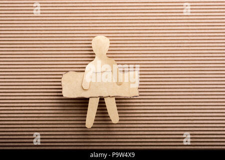 Paper man shape holding burnt note paper in hand Stock Photo