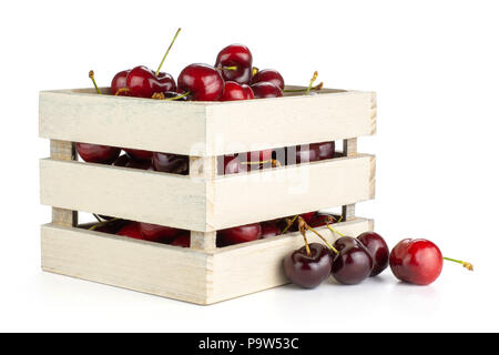 Sweet bright red cherry in a wooden box isolated on white Stock Photo