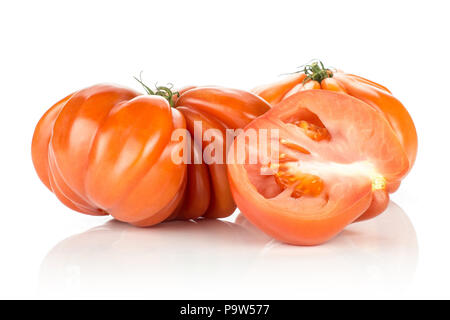Two beef tomatoes and one sliced half isolated on white background big ripe red ribbing Stock Photo