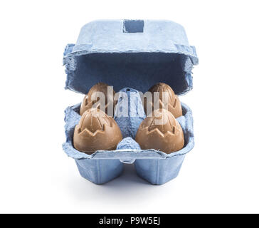 Four chocolate eggs in a blue box isolated on white background Stock Photo