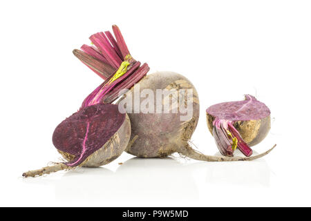One red beet with two halves young bulbs isolated on white background cut tops Stock Photo