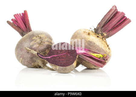 Two red beet and one half young bulbs isolated on white background cut tops cross section Stock Photo
