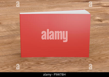 Blank red horizontal soft cover book standing on wooden background. Isolated with clipping path around book Stock Photo