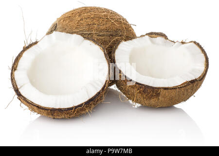 Coconut and one cracked in two halves isolated on white background brown fibrous shell with milk meat Stock Photo