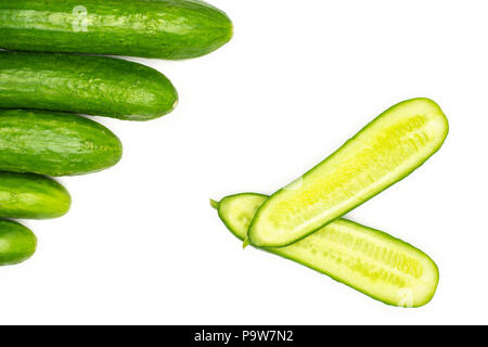 Five fresh mini cucumbers and one cut in two halves flatlay isolated on white background Stock Photo