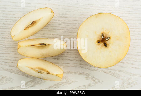 Chinese golden pears top view Nashi variety isolated on white wooden background one cross section half three slices Stock Photo