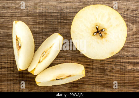 Chinese golden pears top view Nashi variety isolated on wooden background one cross section half three slices Stock Photo