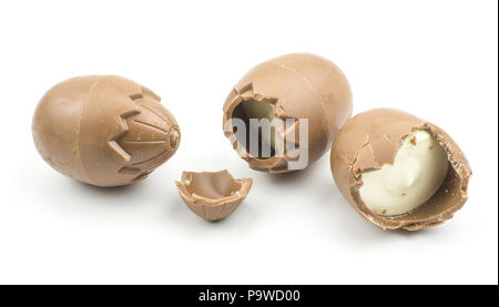 Chocolate eggs one cracked one half and whole isolated on white background Stock Photo