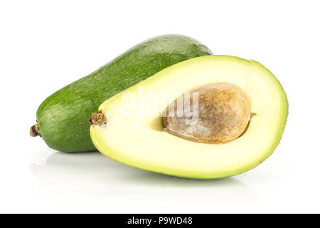 Green smooth avocado and one half with a seed isolated on white background bacon variety Stock Photo