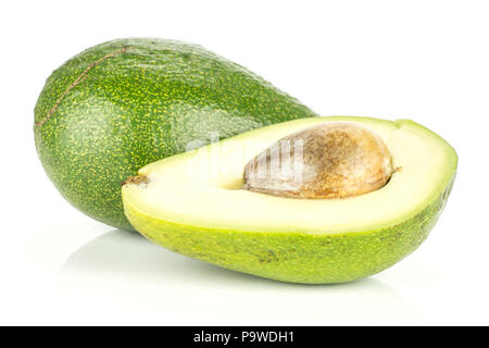 Green smooth avocado and one section half with a seed isolated on white background bacon variety Stock Photo