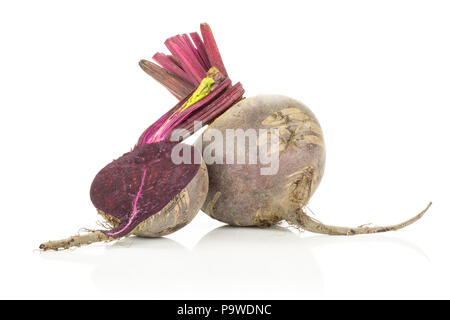One red beet with section half young bulbs isolated on white background cut tops Stock Photo