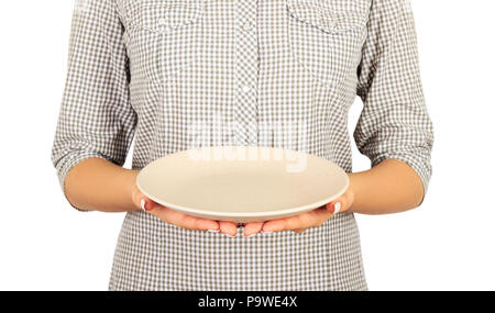 woman holds an empty matte round plate in two hands in front of her. perspective view Template for your design. Isolated on white background. Stock Photo