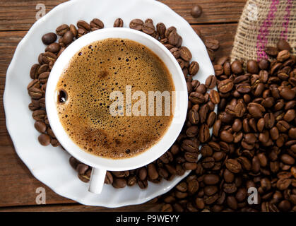cup of coffee and grain on a rustic table Stock Photo