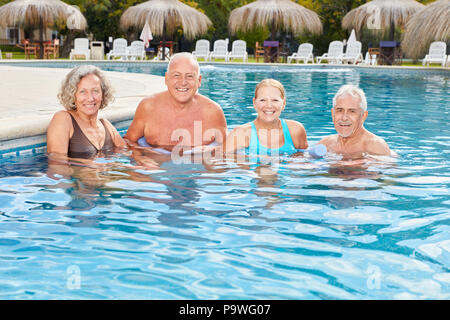 Smiling group of seniors in the spa makes hydrotherapy in rehab Stock Photo