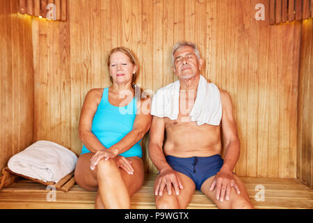 Senior couple enjoys relaxing in the sauna at the Spa Wellness Hotel Stock Photo