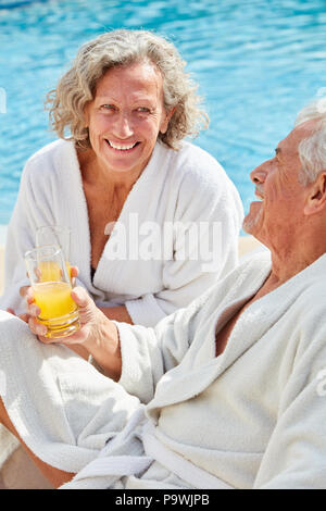Relaxed couple sitting in swimming pool and chatting Stock Photo - Alamy