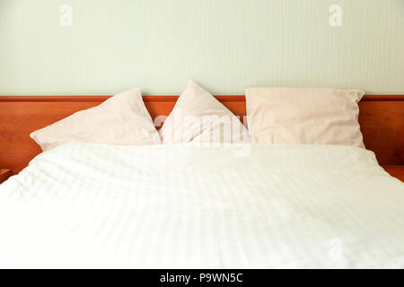 Double bed with wooden back in the hotel room. Stock Photo