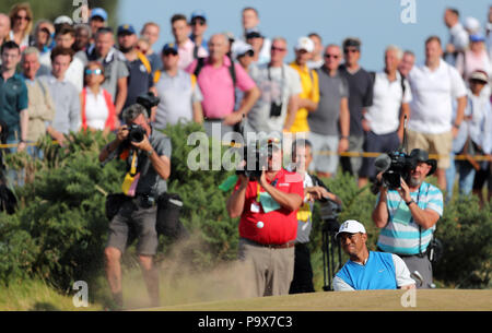 USA's Tiger Woods chips out of a bunker on the 9th during day one of The Open Championship 2018 at Carnoustie Golf Links, Angus. Stock Photo