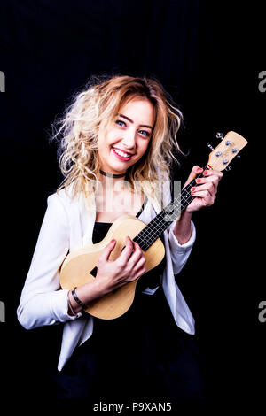 Ukulele, Plucked string instrument, girl playing Ukulele, string instrument, playing Ukulele, Ukulele player, teen Ukulele player, instrument, musical Stock Photo