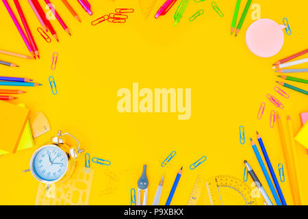 back to school styed frame with muilticolored school supplies on yellow ...